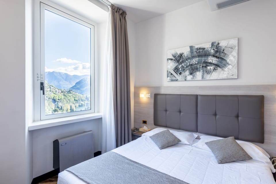Standard Double Room, Partial Lake View | Minibar, in-room safe, desk, laptop workspace