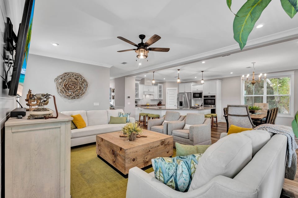 The spacious living room, complete with a smart TV, is ideal for movie nights, while the adjoined porch provides ample seating for outdoor gatherings.
