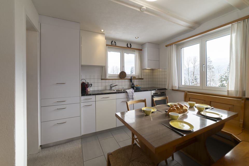 Bright kitchen with dining area and set breakfast table