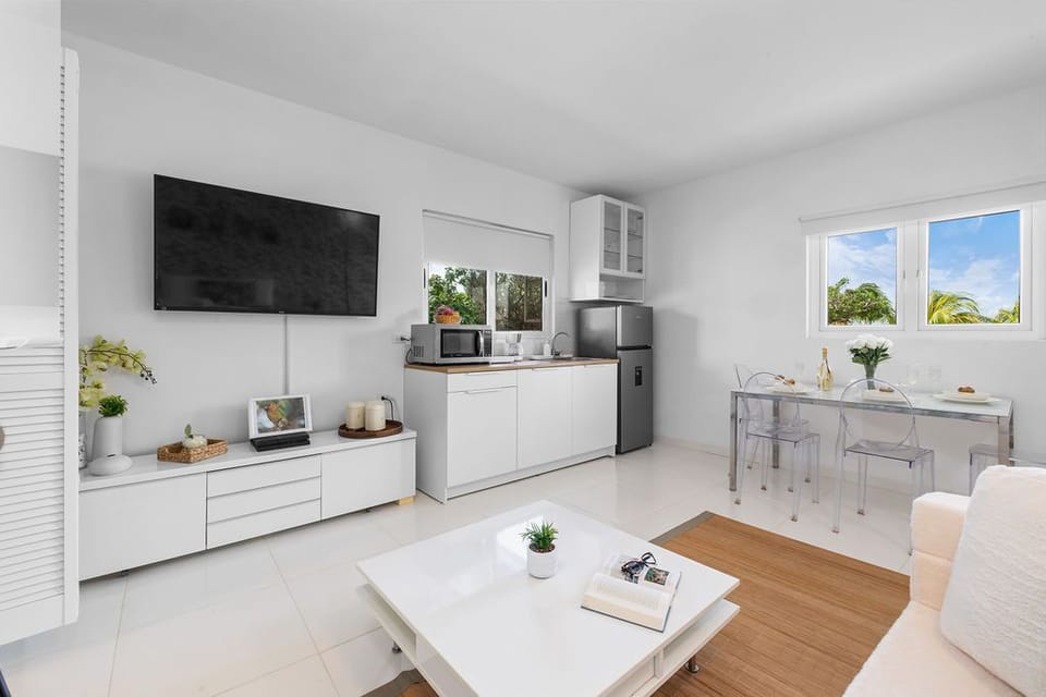 Open area features a living room, dining area, and kitchenette, all in one in this incredible apartment.