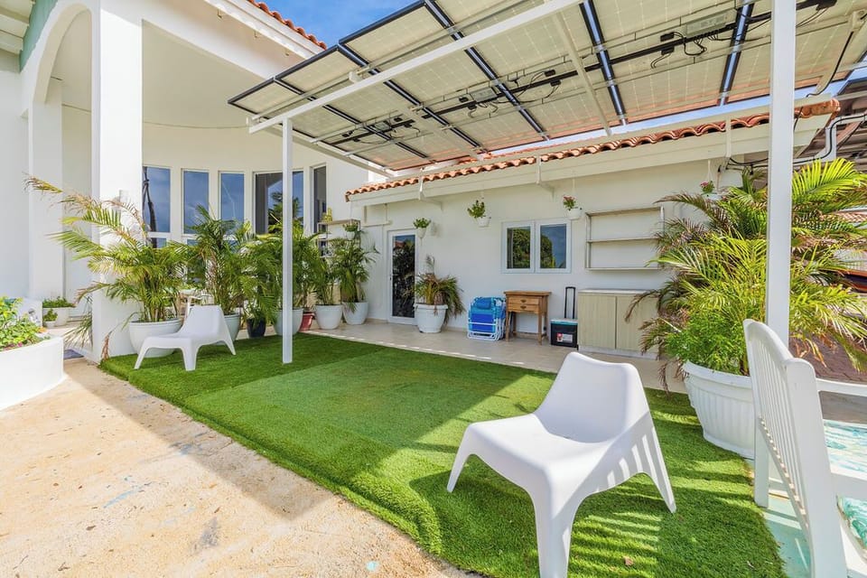 The entrance features a small area with extra storage and tables. We also provide beach chairs and coolers for your convenience.