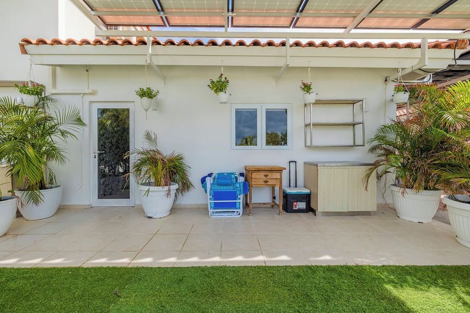 The entrance features a small area with extra storage and tables. We also provide beach chairs and coolers for your convenience.