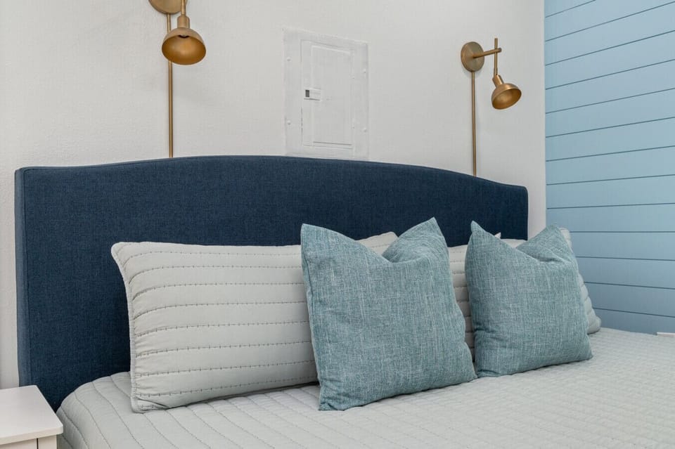 Elegant bed with a sleek headboard and two bedside lamps, creating a warm and inviting atmosphere.