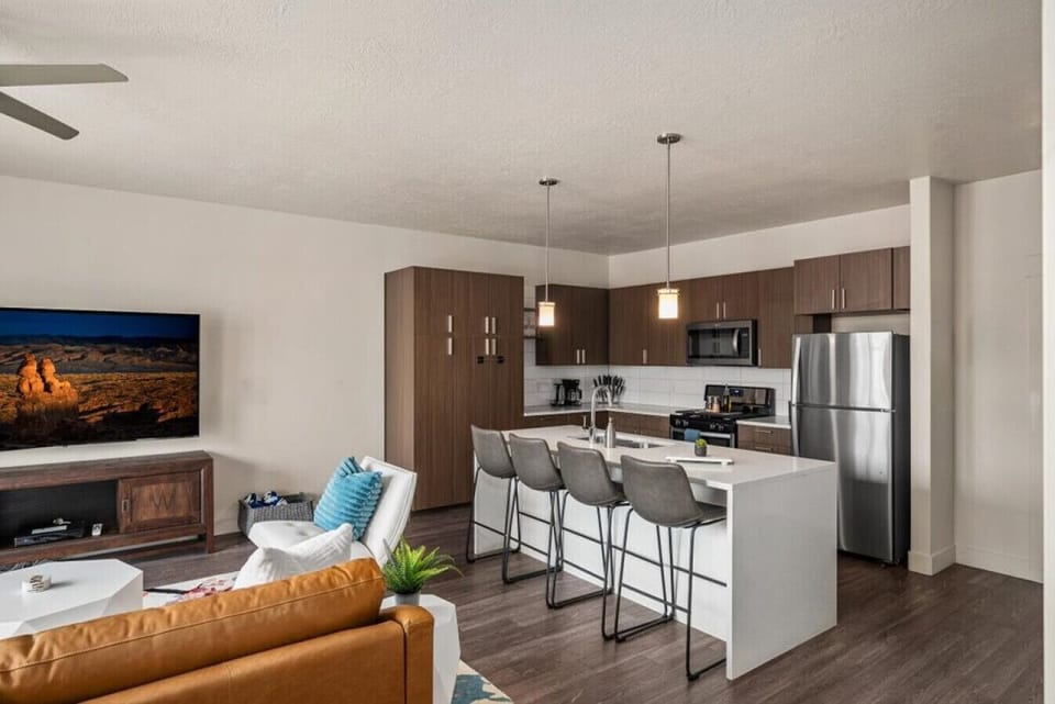 Beautifully designed living room. 75` TV, leather sleeper sofa and amazing views of mountains and city skyline.