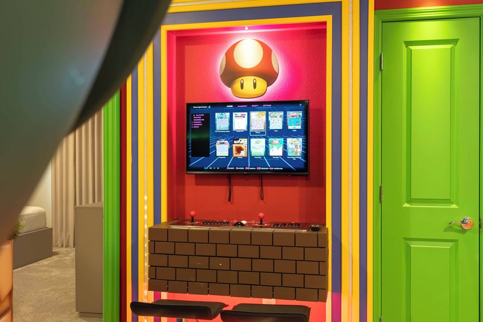 Welcome to our vibrant gaming nook, where colorful walls and playful decor create a fun atmosphere. Enjoy family bonding and gaming excitement in this inviting space with whimsical decor and a bright green door.