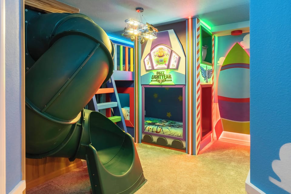 Discover a vibrant play area bursting with joy, complete with a sleek green slide and colorful, whimsical graphics. This lively space encourages creativity and fun, making it the perfect spot for kids to explore and enjoy.