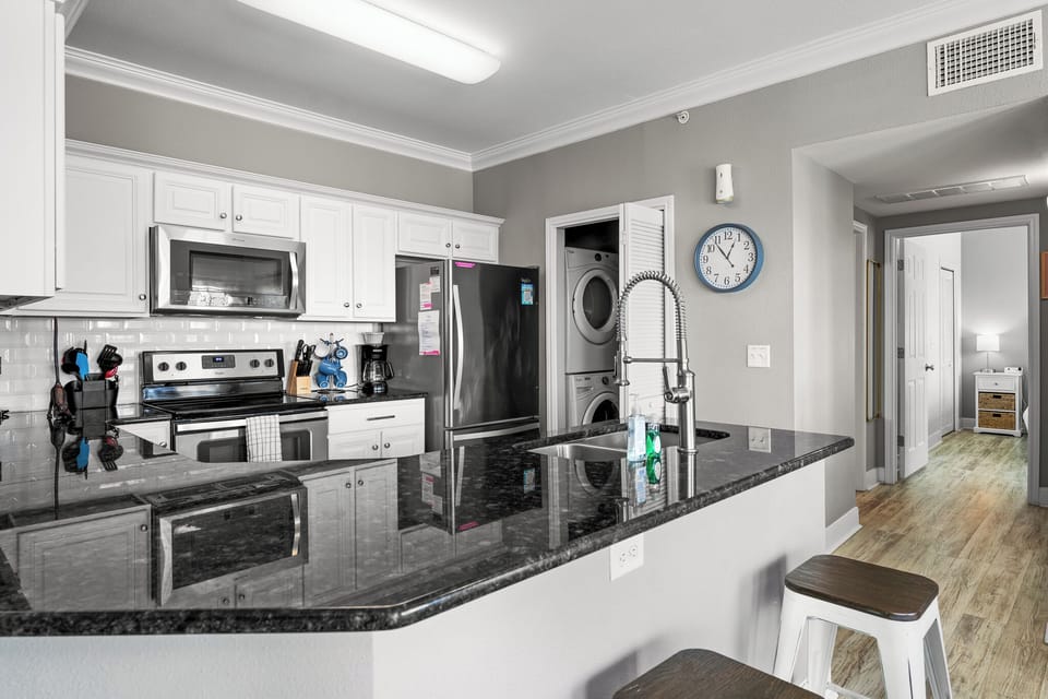 Step into this stunning kitchen featuring modern stainless steel appliances that elevate your cooking experience! Perfectly designed with ample cabinetry and a sleek countertop, it's an inviting space for both culinary creativity and entertaining.