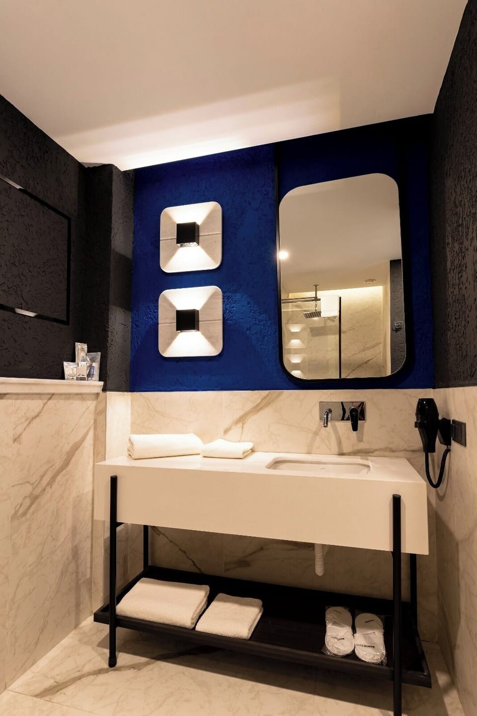 Shower, hair dryer, slippers, towels