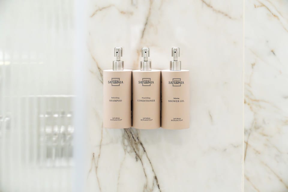 Shower, rainfall showerhead, designer toiletries, hair dryer