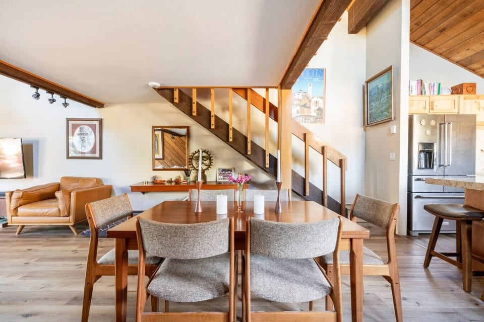Spacious dining area with warm wood finishes, comfortable seating, and an open layout, perfect for shared meals and group gatherings.