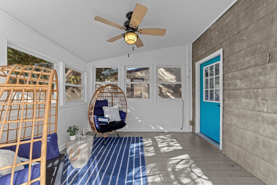 Sun room with ceiling fan and egg chairs
