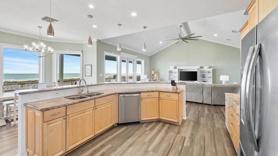 Beautiful wood cabinetry and a spacious kitchen island with seating for casual dining or keeping the chef company.