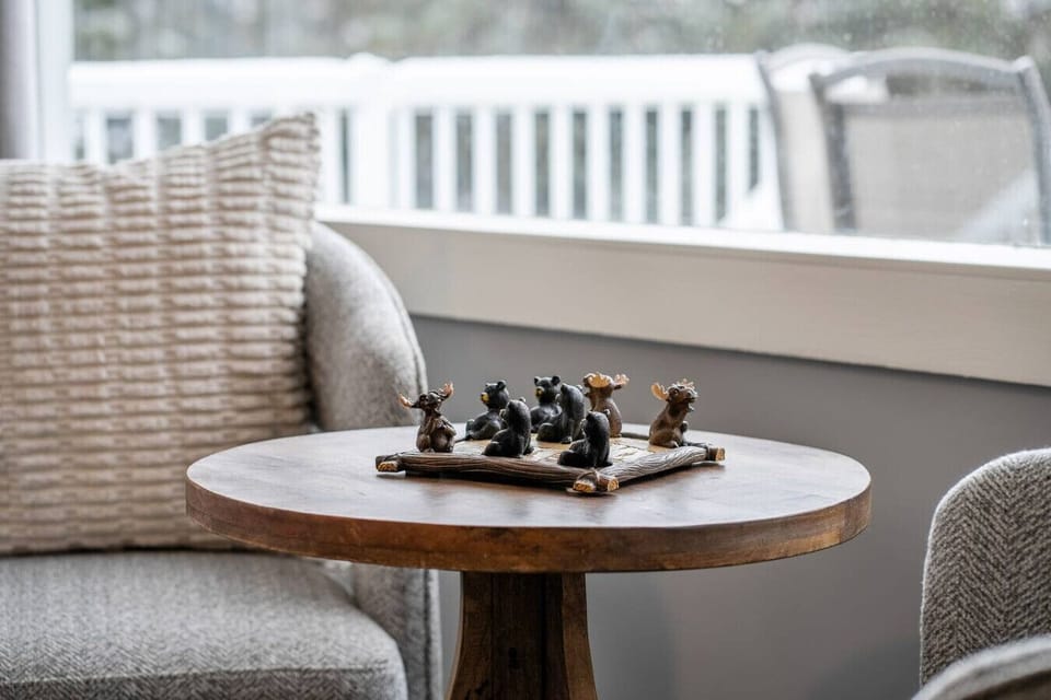 Living room with a wood-burning fireplace, board games, a Smart TV, cozy seating & more. There`s also a single rollaway cot (with bedding) for additional sleeping space.
