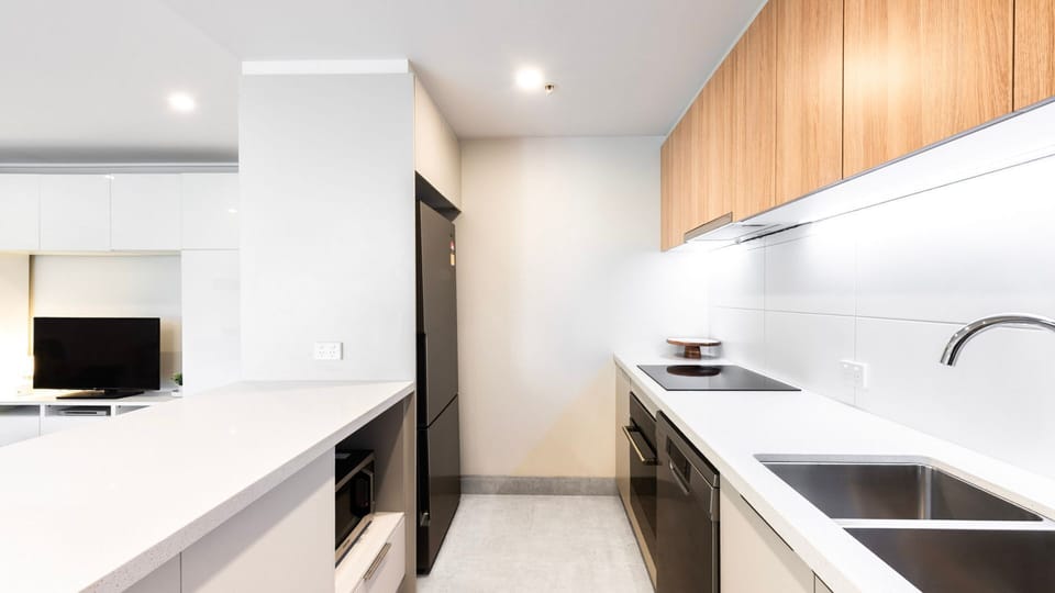 Sleek, modern kitchen with full appliances and generous counter space