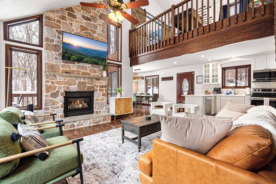 Open concept living area featuring cozy fireplace and Smart TV.