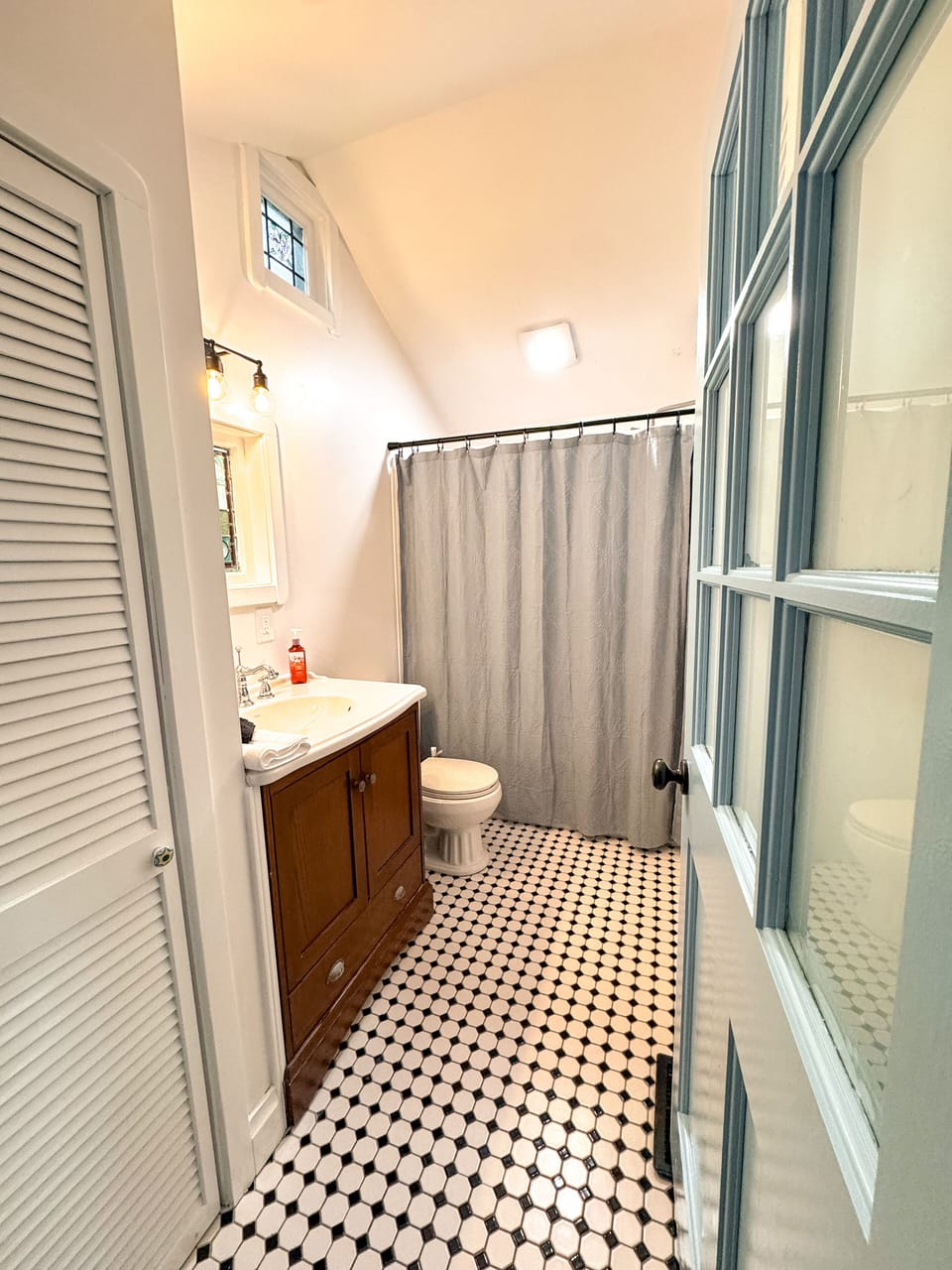 Bright bathroom with a convenient shower and tub combination.