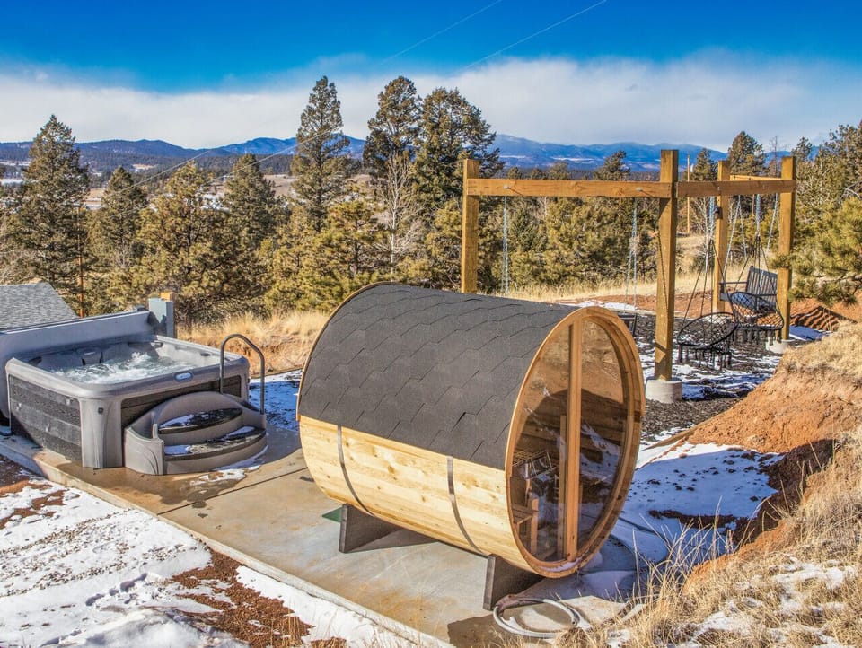 Outdoor area with hot tub, sauna, giant `swing set` and mountain views