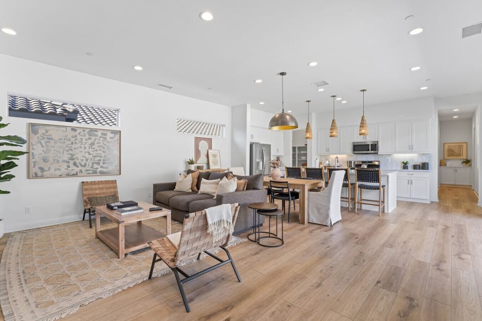 Modern open living & dining space w/ natural light & sleek finishes throughout