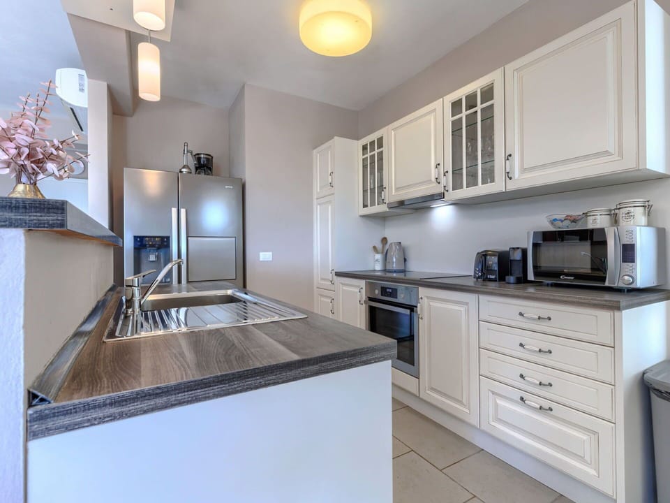 Countertop, Kitchen, Kitchen Appliance, Cabinetry, Furniture, Interior Design, Major Appliance, Flooring, Wood, Home Appliance