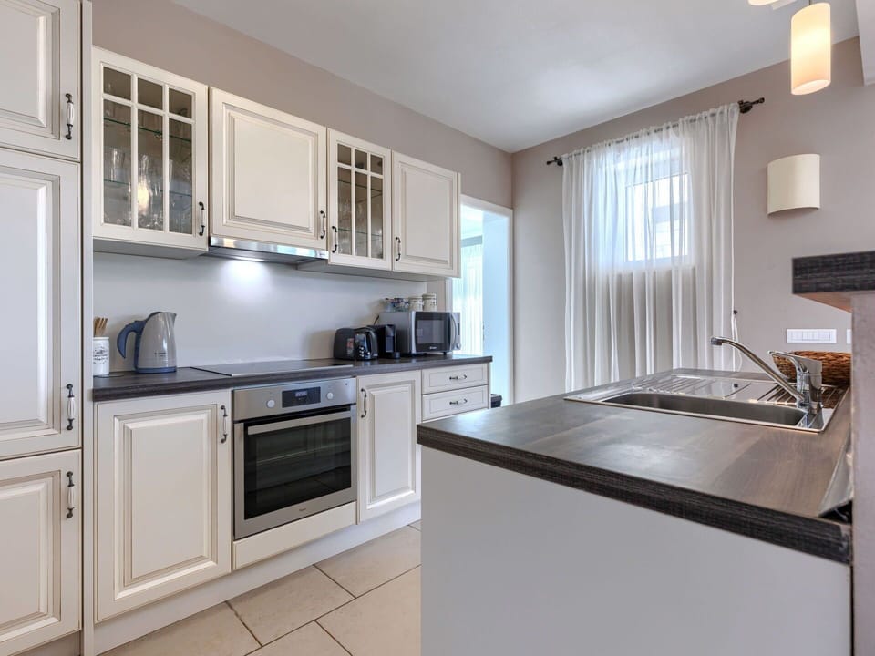 Countertop, Kitchen, Cabinetry, Kitchen Appliance, Interior Design, Furniture, Major Appliance, Flooring, Wood, Light Fixture