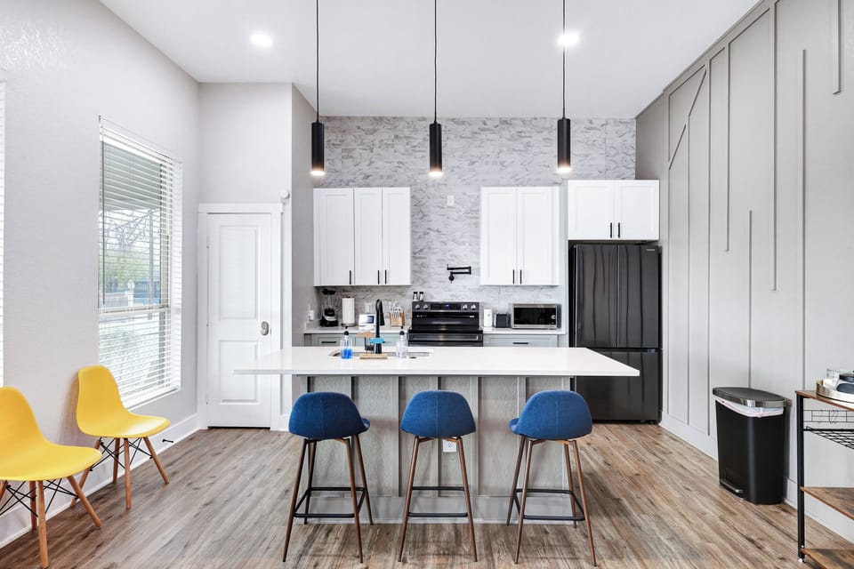 Spacious kitchen island that sits 3 with full tableware and silverware included.