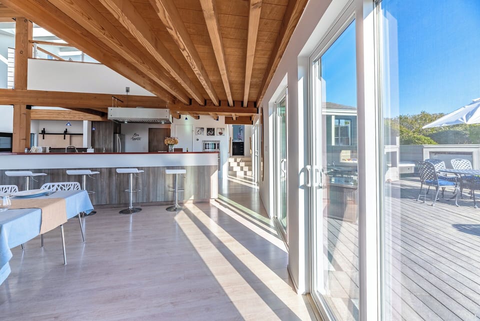 A wall of sliding glass doors invite you to enjoy the ocean bree