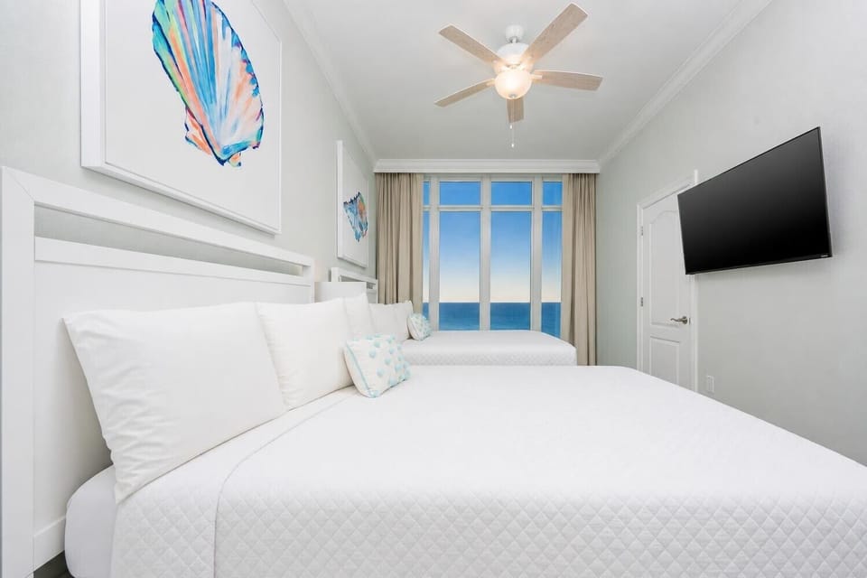 Turn on the TV, settle onto soft pillows, and admire the beach from this charming queen suite