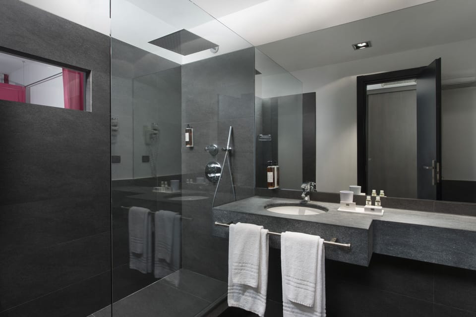 Suite, Balcony | Bathroom | Rainfall showerhead, hair dryer (on request), bidet, towels