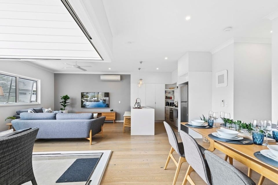Dining beside the kitchen and patio, connected to indoor-outdoor living.