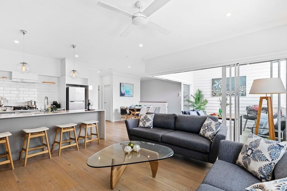 Bright open-plan lounge and breakfast bar; close bifolds when using BBQ.