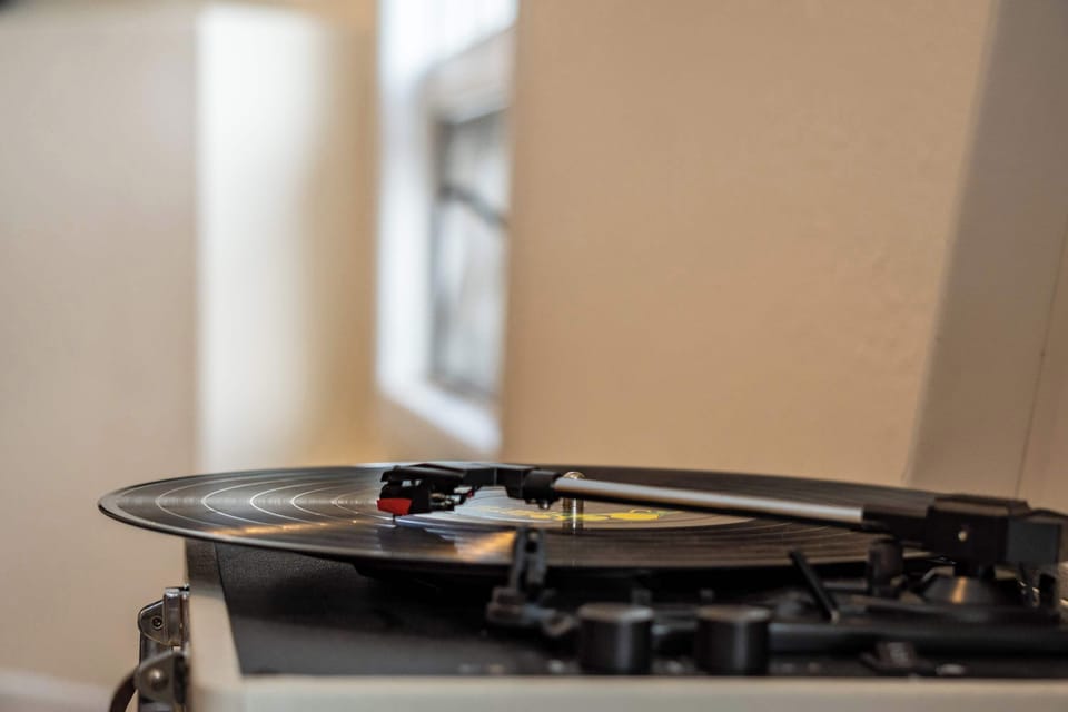 Record player with assortment of records.