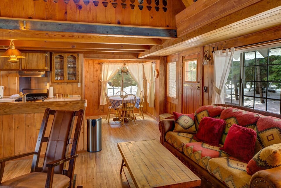 Cozy living room adjacent to kitchen and dining area with wood burning stone fireplace, SmartTV and dining area!