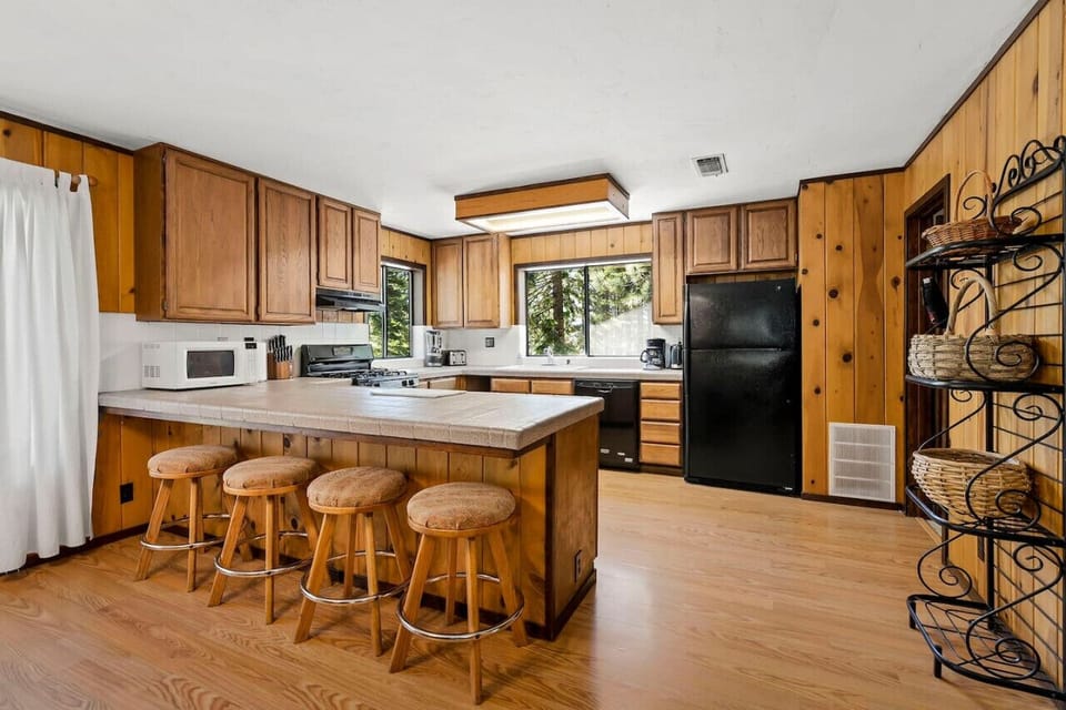 Large Open Great Room (Living Room / Kitchen / Dining) with Wood Burning River Rock Fireplace and Spacious Wrap Around Covered Deck!