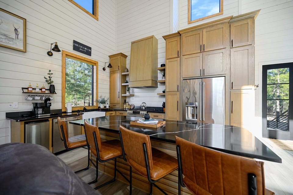 A spacious kitchen island with bar seating—perfect for hosting gatherings or enjoying casual meals. Plus, a high-end refrigerator that not only keeps your food fresh but also offers hot and co