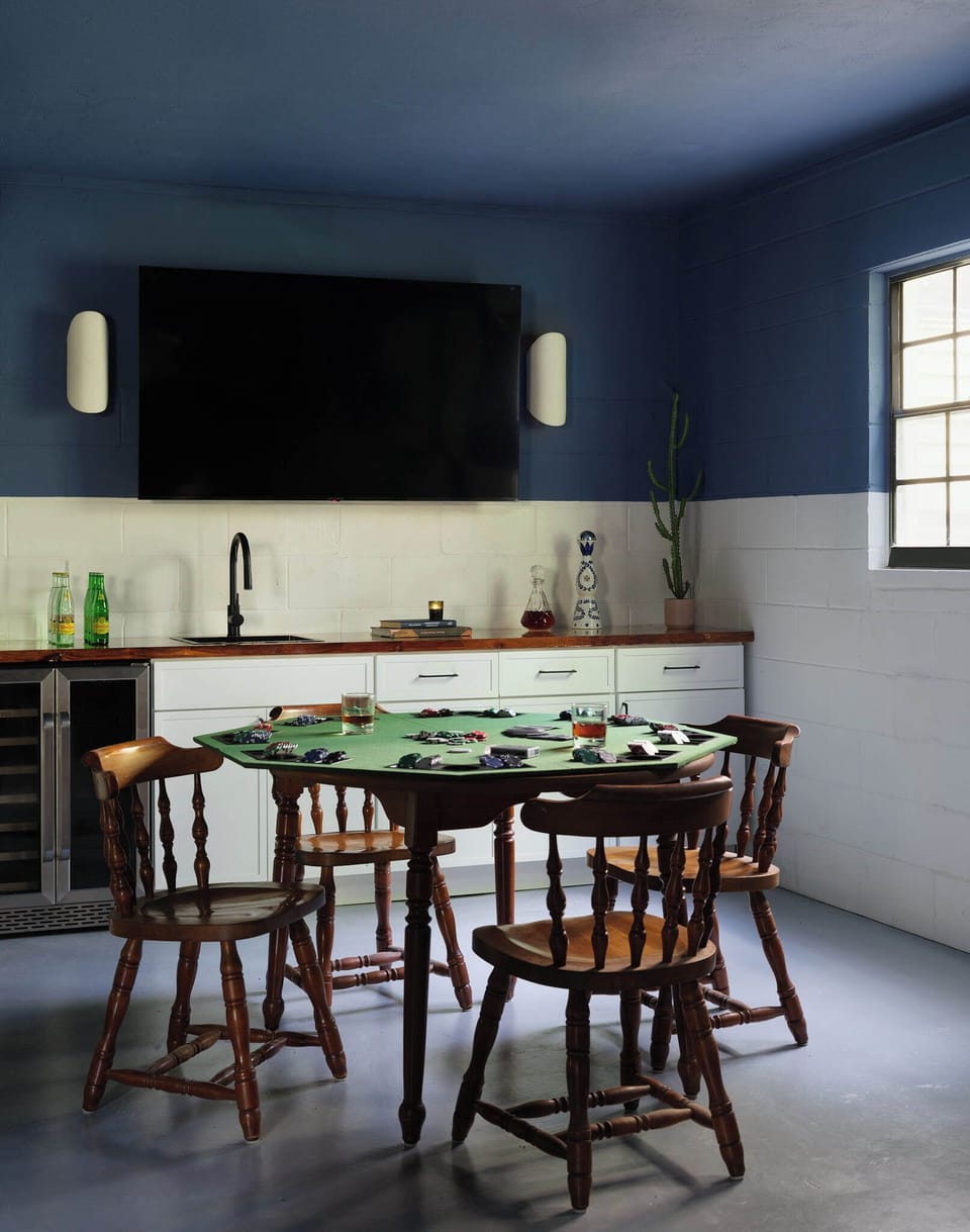 Game room wet bar with poker table, TV, beverage fridge & cactus decor