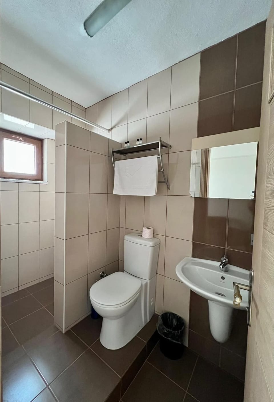 Shower, hair dryer, slippers, towels