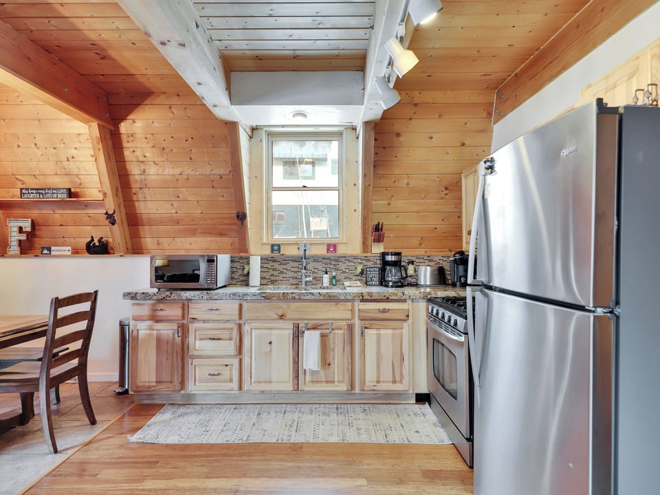 View of the kitchen featuring stainless steel appliances and fully stocked with everything you need to prepare meals and enjoy your time at the cabin