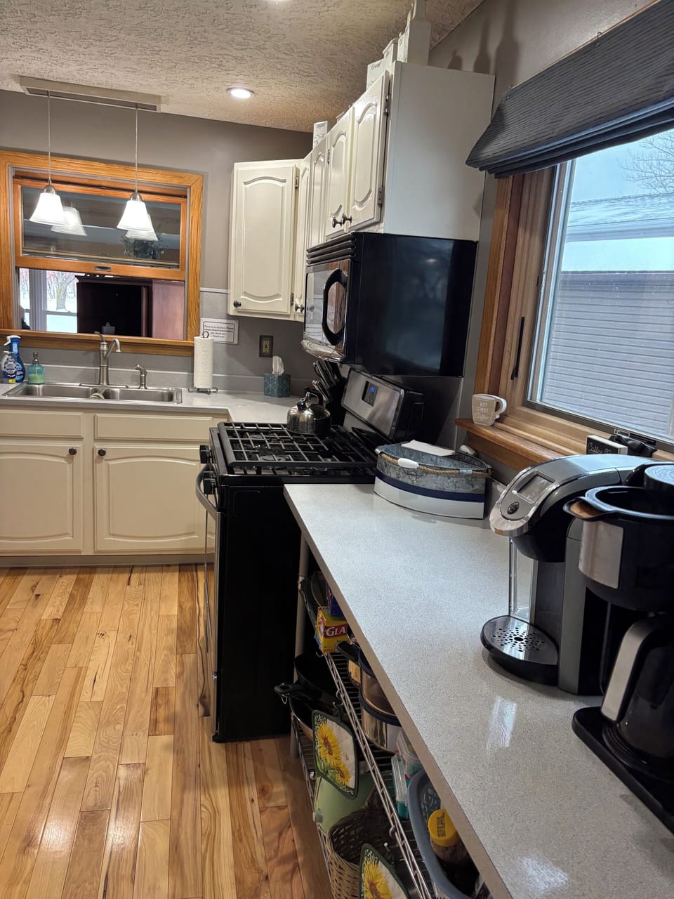 Pots, pans, small appliances, and coffee bar set-up in the kitchen.