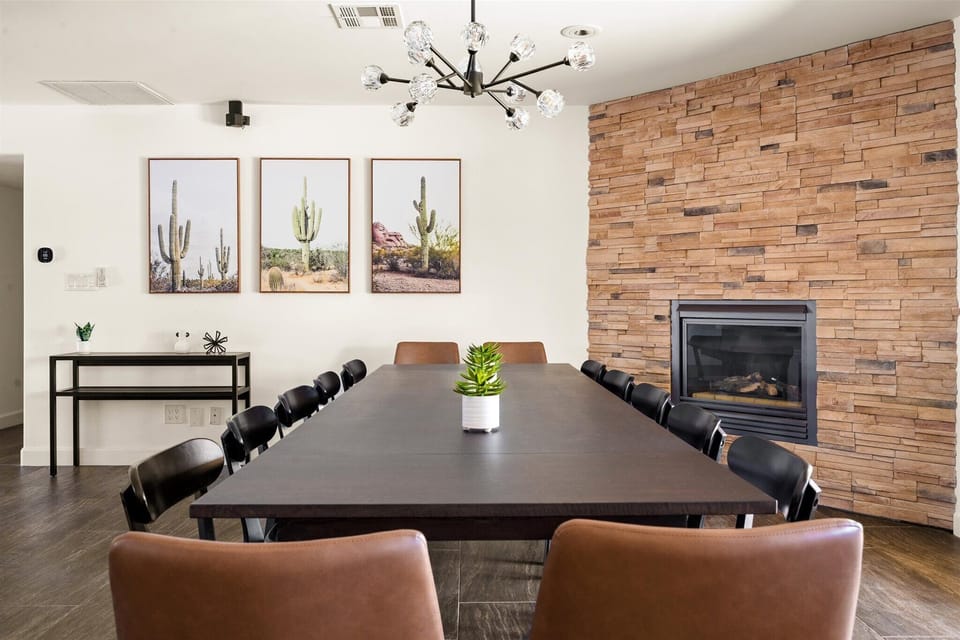 14-seat dining table with fireplace and modern art — perfect for holiday dinners and group celebrations.