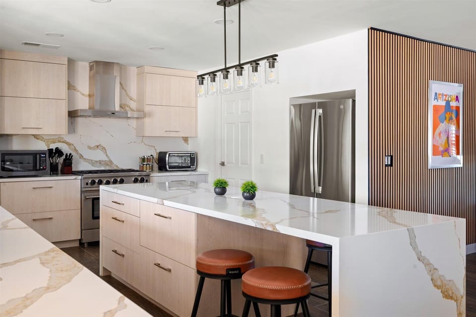 Solid counters, stainless steel appliances, and barstool seating — ideal for preparing meals for large groups.