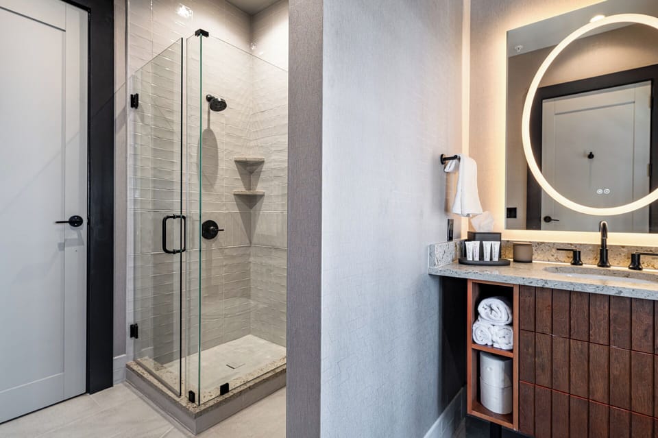 Bathroom 2 - Spacious walk-in shower with glass doors and modern fixtures.