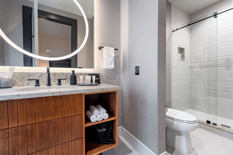 Bathroom 1 - Contemporary bathroom with ambient lighting and complimentary toiletries—ideal for unwinding after a day of exploring the city.