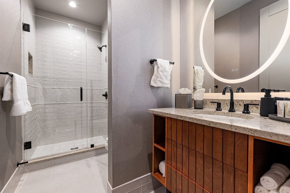 Bathroom 1 - Contemporary bathroom with ambient lighting and complimentary toiletries—ideal for unwinding after a day of exploring the city.