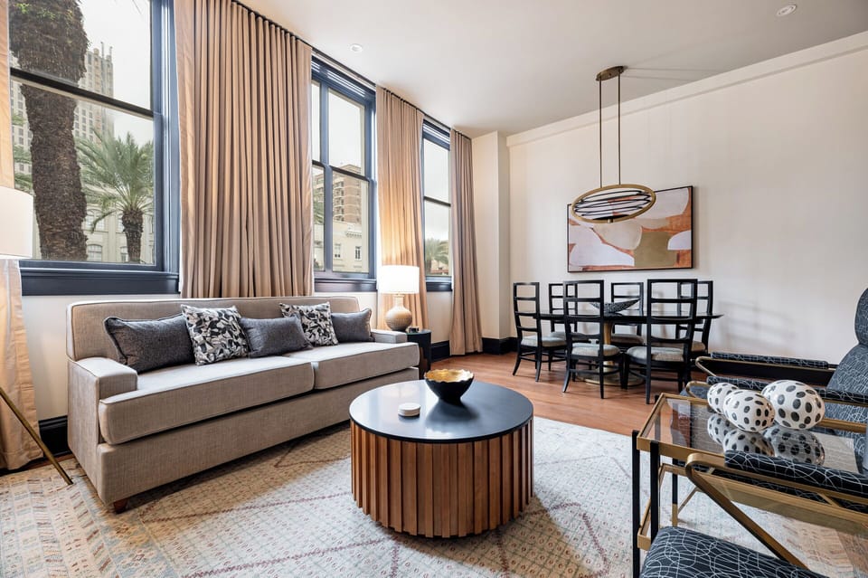 Enjoy the natural light in this open-plan living and kitchen area with high ceilings and large windows that offer views of Canal Street.