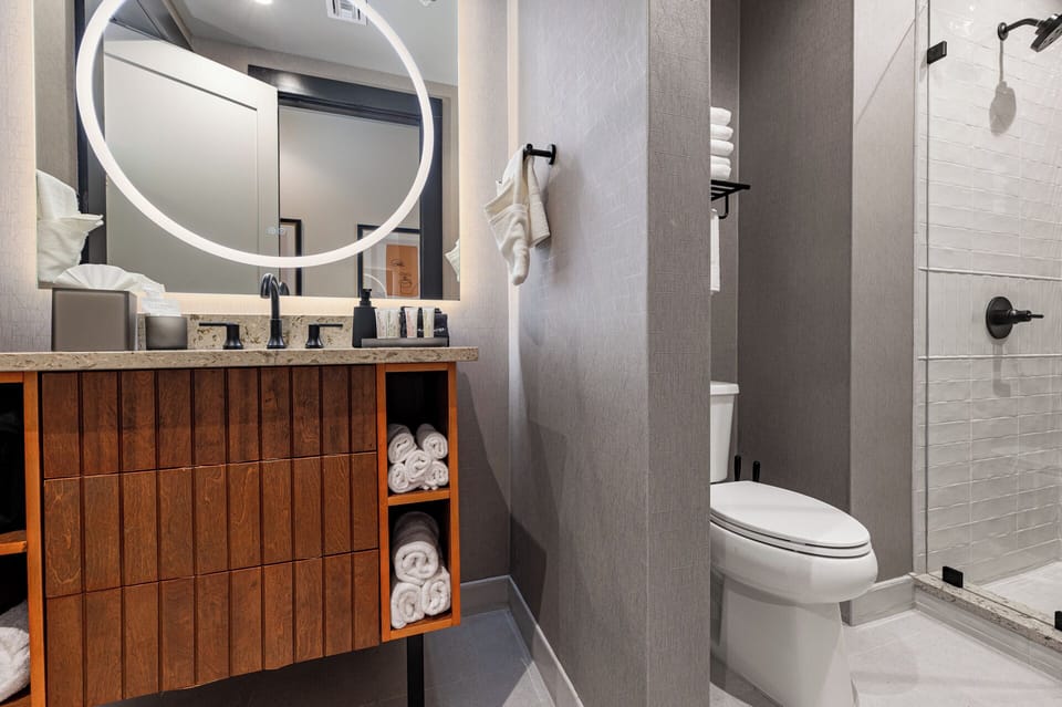 Bathroom 1 - Contemporary bathroom with ambient lighting and complimentary toiletries—ideal for unwinding after a day of exploring the city.