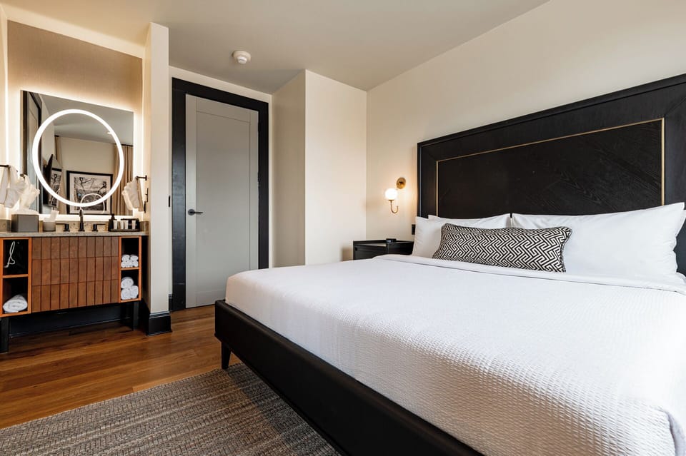 Bedroom 1 - King bed featuring a built-in wardrobe, flat-screen TV, and en-suite bathroom.