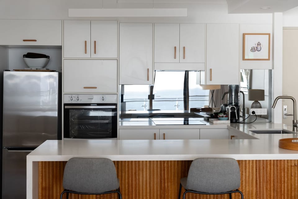 Ocean Front Escape on Palm Beach | Private kitchen | Electric kettle, toaster, cleaning supplies, freezer