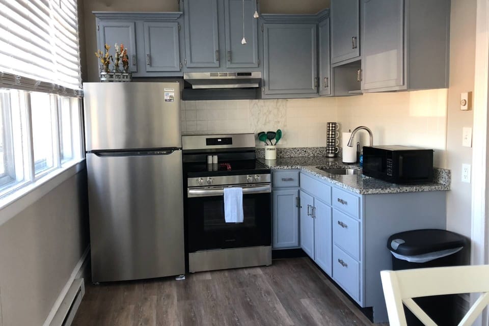 Fully stocked kitchen has ample dishes, glasses, silverware, bowls, pots and pans for quick food on the run or full meals.