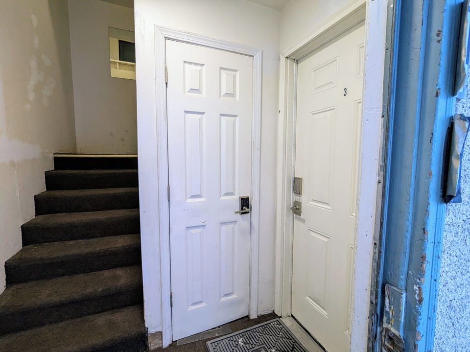 Shared Arctic Entry/mudroom.  Doors are equiped with security code.