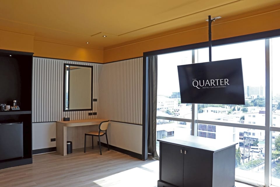 Deluxe Triple Room | Minibar, in-room safe, laptop workspace, blackout drapes